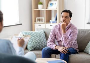 man listening to therapist in anxiety treatment