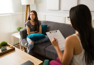 young woman in therapy with mental health professional