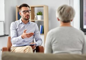 male therapist explaining ocd treatment to patient in an office setting