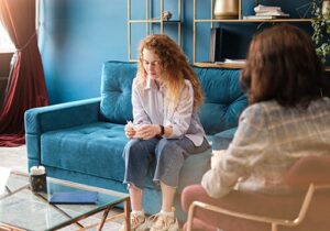 therapist explaining to young woman the benefits of borderline personality disorder treatment