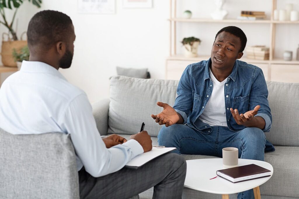 young man talking to his male therapist about finding a depression treatment program in denton, texas