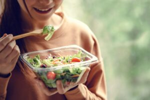 woman eating nutritious meal because she understands how diet impacts your mental health
