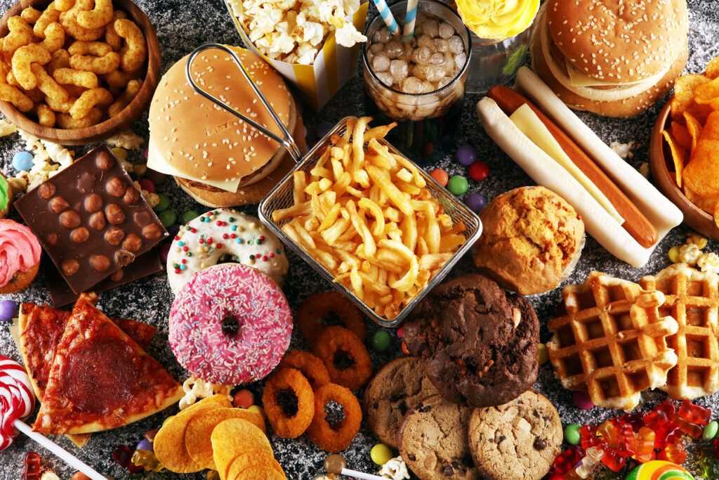 a table loaded with various kinds of food and sweets representing how your diet can impact depression, especially during holidays.