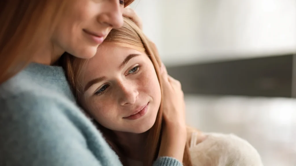 Parent talking with a teenager about starting an adolescent group therapy treatment program